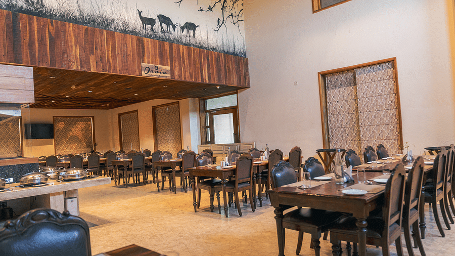 Oasis Restaurant dining area with tables and chairs arranged and a buffet counter on the side